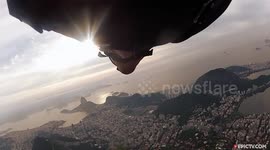 Stunning moment wingsuit pilot flies under arm of Christ the Redeemer in Rio