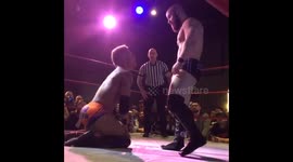 Pro wrestling: Wrestlers kicks other wrestler very hard in chest.