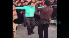 Woman and man in bizarre public dance off in China