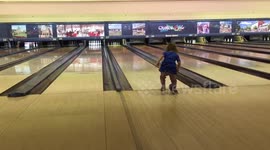 Little girl taken bowling by her dad... doesn't quite get it