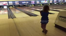 Little girl taken bowling by her dad... doesn't quite get it