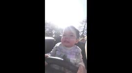 Young child pulls hilarious faces as he rides a roller coaster for the first time