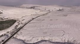 Drone shows snow coating Northern Ireland mountain pass