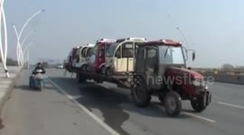 'Unlicensed' tractor loaded with seven cars drives into town