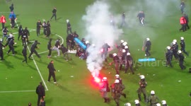 Violent clashes at Greek football match after mass pitch invasion