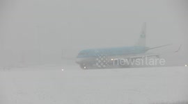 Plane landing in difficult, snowy conditions at Leeds Bradford Airport