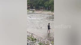 Adventurer cruises above river on flying human drone
