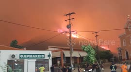 Hospital patients evacuated and church bells ring as wildfire encroaches on Greek city