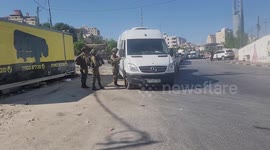 Israeli security forces man a checkpoint at the closed-off southern entrance of Hebron city in the West Bank, near the Israeli settlement of Beit Haggi (background) where a settler killed a day earlier in a shooting attack resided.