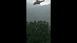 Child dangles from helicopter as first person rescued from stranded cable car in Pakistan