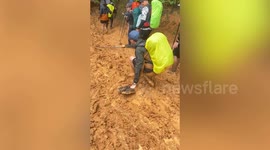 Hikers slip down muddy hill following heavy rain in Thailand