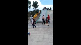 Boy on Slide Accidently Crashes Into Lady
