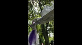 stilt walker performance with a big flag, festival performance - dancing on stilts