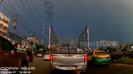 Lightning strikes down from the heavens as cars queue in traffic jam