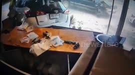 Toddler grabs steering wheel causing mum's car to crash into shop