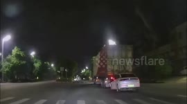 Heroic motorist races to stop truck unknowingly dragging car on Chinese road