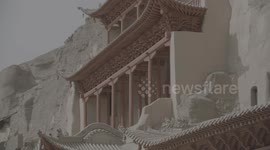 Pan and shoot the outer tower of Mogao Grottoes in Dunhuang City, Gansu Province from bottom to top.