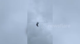 Tourist stuck on zipline high above onlookers in the Philippines