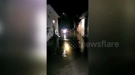 Rescue officials come to the aid of people stranded in submerged houses in northern India