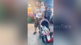 Father pushes stroller to cradle baby... forgetting he is holding infant in his arms