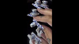 Woman leaves TikTok users in shock after adding complete TEA SET to her nails Part 1/3