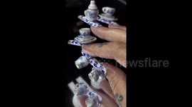 Woman leaves TikTok users in shock after adding complete TEA SET to her nails