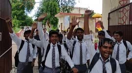 Students celebrate as they watch India's first successful Moon landing