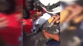 Indonesian firefighters rescue toddler's leg trapped in badminton net hole during national anniversary celebration