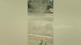 Dust devil whirls in front of temple in Indonesia