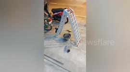 Mechanic grills chicken thigh using electric hand drill