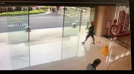 Delivery man distracted by phone crashes into glass door in China