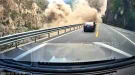 Cars reverse to escape as rocks tumble down mountain in southern China
