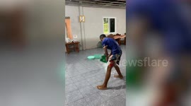 Family battles to mop up flood water inside home during monsoon storm