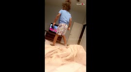 Little boy shoots himself off from the bed's edge trying to flip like Spider-Man