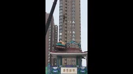 Daredevil digger operator dangles from arch for demolition in China