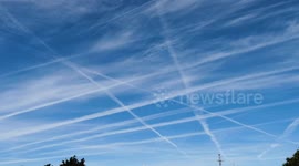 Vast Contrails cover mid Cornwall as transatlantic aircraft cause largely avoidable climate negatives. Fraddon, Cornwall, UK