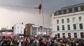 Tight rope Walker in Woolwich amazes local people on the opening night of the Greenwich and Docklands International Festival. Tye performance of Open Lines by Cie Basinga went down a storm as tight rope Walker Tatiana Mosio Bongonga wowed the crowed below
