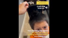 Boy gets his head caught in a mouse trap