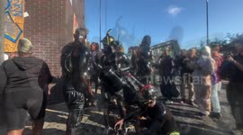 Notting Hill Carnival participants cover themselves in oil and don devil horns in opening ceremony