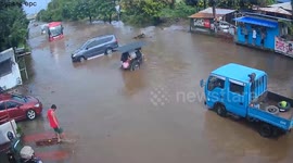 Truck plunges into flooded ditch as Typhoon Saola batters the Philippines
