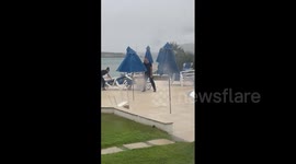 Menorca hotel staff battle to prevent loungers and parasols from blowing away in storm