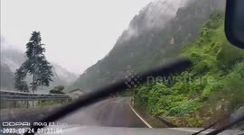 Driver narrowly misses boulder falling from hillside in China