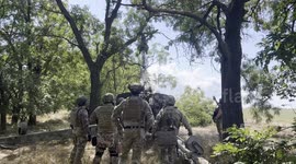 Soldiers utilize artillery vehicle to clear blocked roads by tree cutting