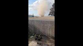 Large And Silent Dust Devil Sweeps Across Backyard