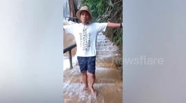 Tourist climb stairs leading to beautiful waterfall in Thailand
