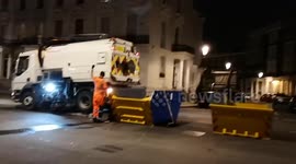 A rubbish van drops of rubbish into a skip as part of the cleanup of the Notting Hill Carnival
