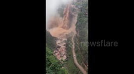 Rainstorm triggers massive waterfall, blocking mountain road in China