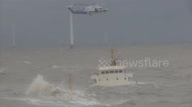 Rescuers battle to save crew on two sinking cargo ships in China