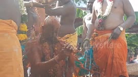 Hindu priest sits on swords then gets bathed in 108kg of chilli sauce in south India