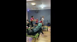 Amusing trampoline mishap: laughter and support amidst slippery fun